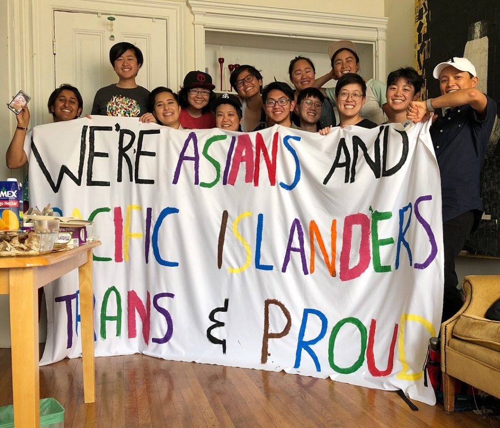 Image description: a group holding “We’re Asians and Pacific Islanders, Trans and Proud” banner