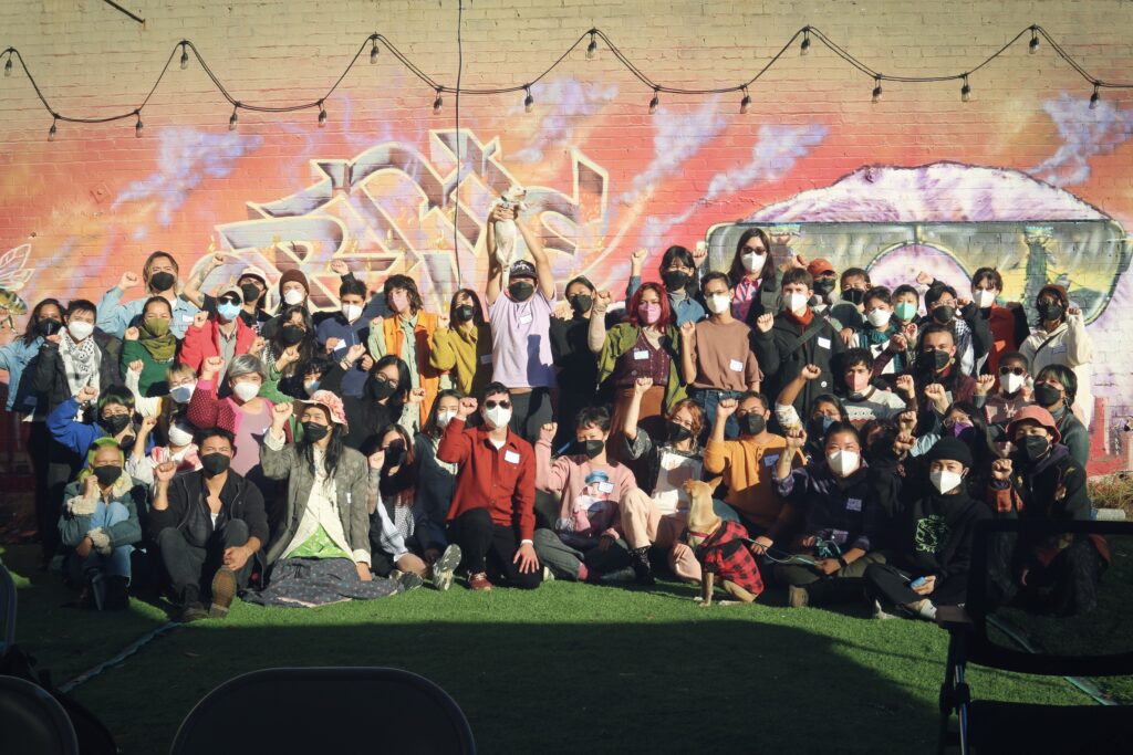 Image description: LavNix members hold their fists up in a group photo.