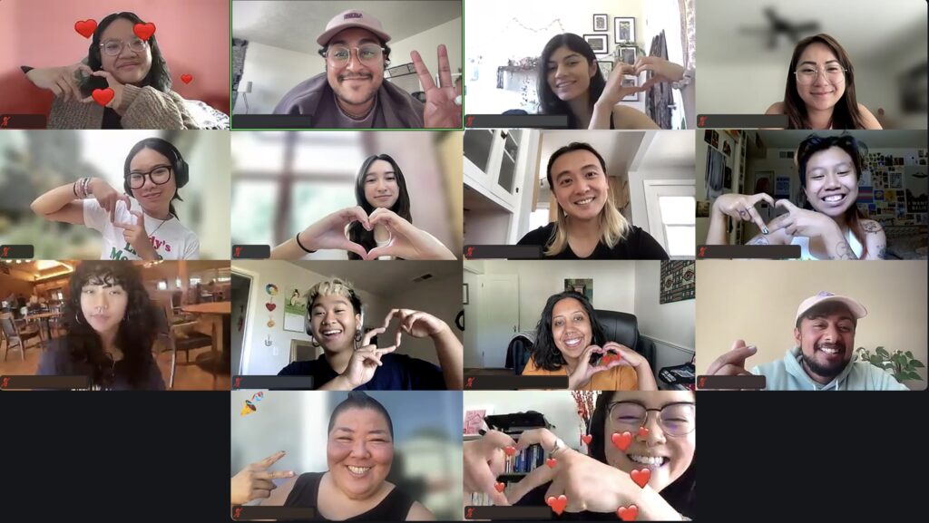 Image Description: Over Zoom, 14 queer and trans API folk pose with hearts and peace signs during our last day of our 2024 Summer Organizer Program.